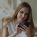 Young woman holding credit card and smartphone